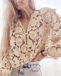 Women's loose black lace cardigan with three-dimensional white floral decoration and a V-neck.
