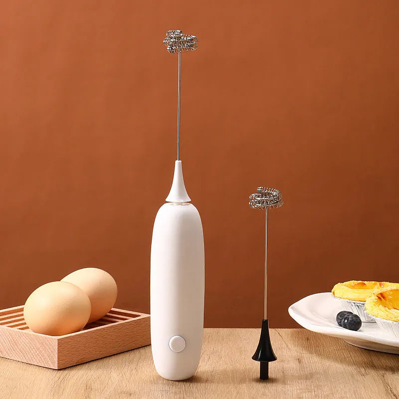 Black and white hand-held electric milk frother blender for coffee beverages