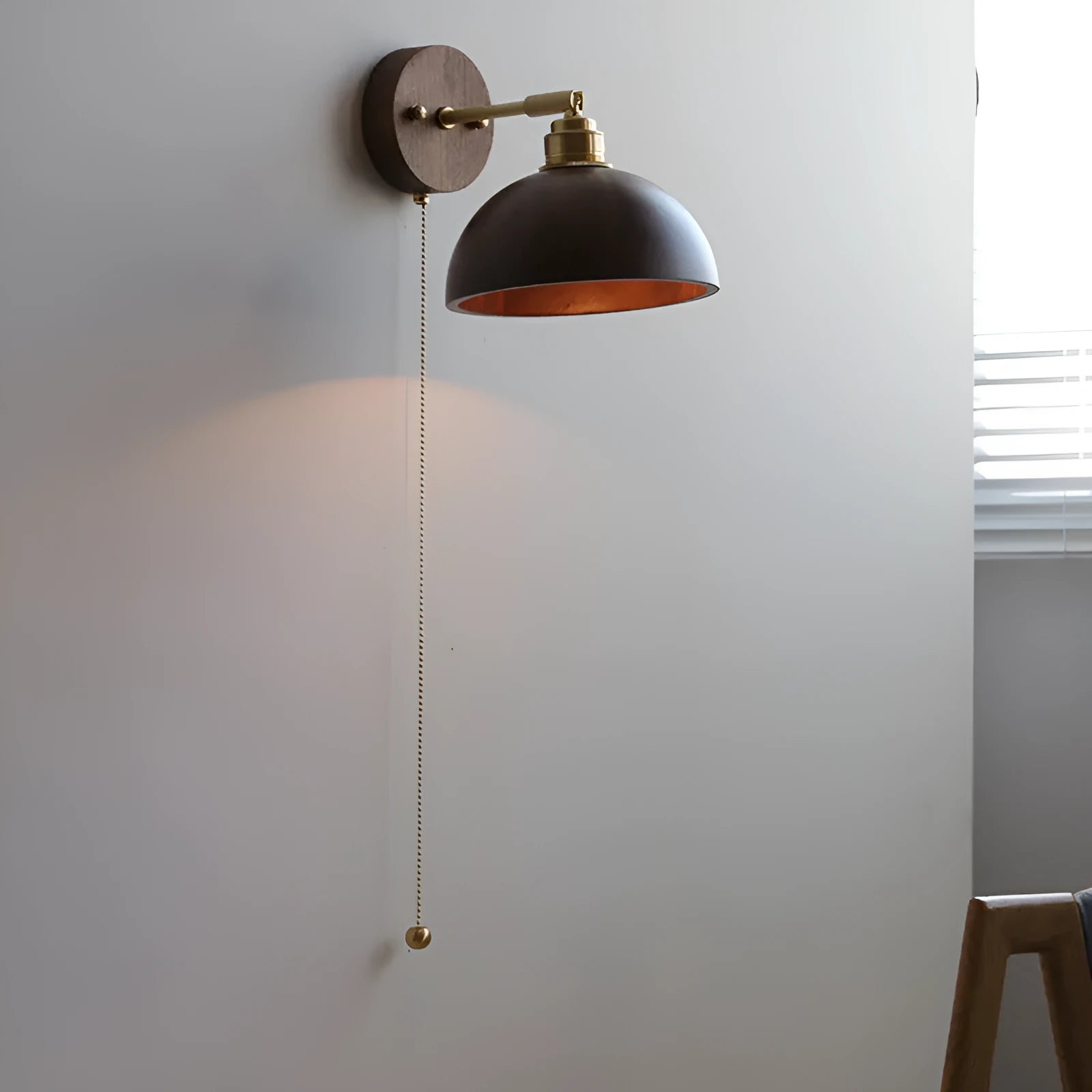 Inn Niche Nordic style bedside wall lamp with walnut colour finish mounted above a bed