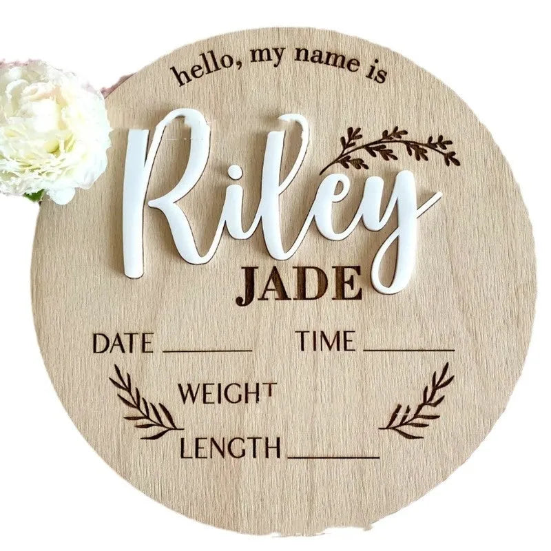 Square wooden baby birth information plaque with engraved details on a plywood base.