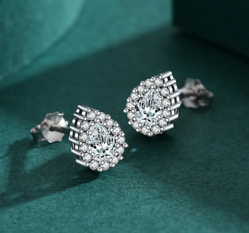 Silver drop-shaped ear studs with diamond-cut surface detail on 925 sterling silver