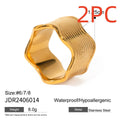 Stainless steel geometric wave pattern ring on a hand, showcasing its wide band and electroplated finish.