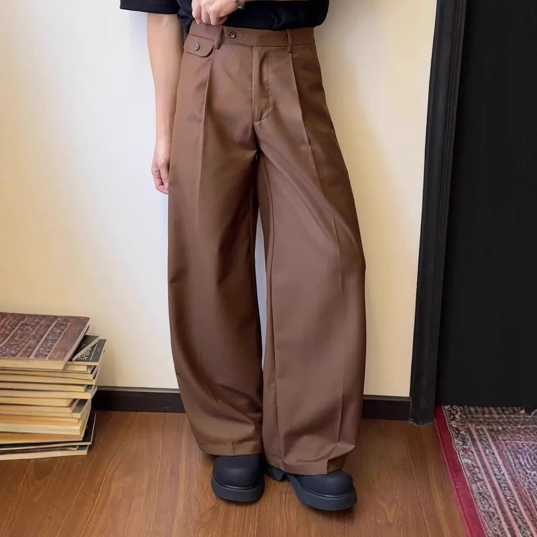 Men's brown straight-leg casual suit trousers with a loose, wide-leg fit on a hanger.