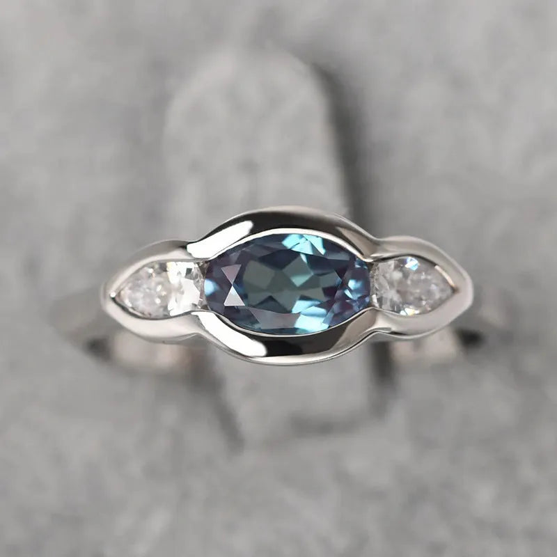 Geometric ellipse ring with inlaid zircon stones in white gold colour finish
