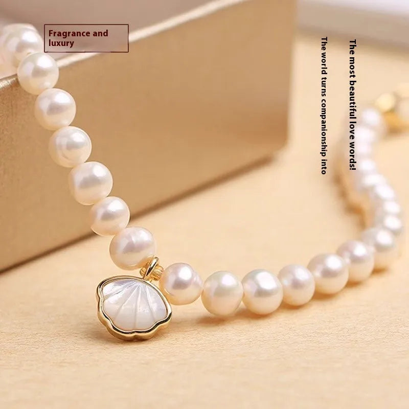 Freshwater pearl bracelet with fan-shaped shell design showing pearls on elastic or chain option