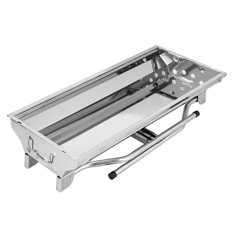 Stainless steel portable folding barbecue oven with large grill, shown outdoors.