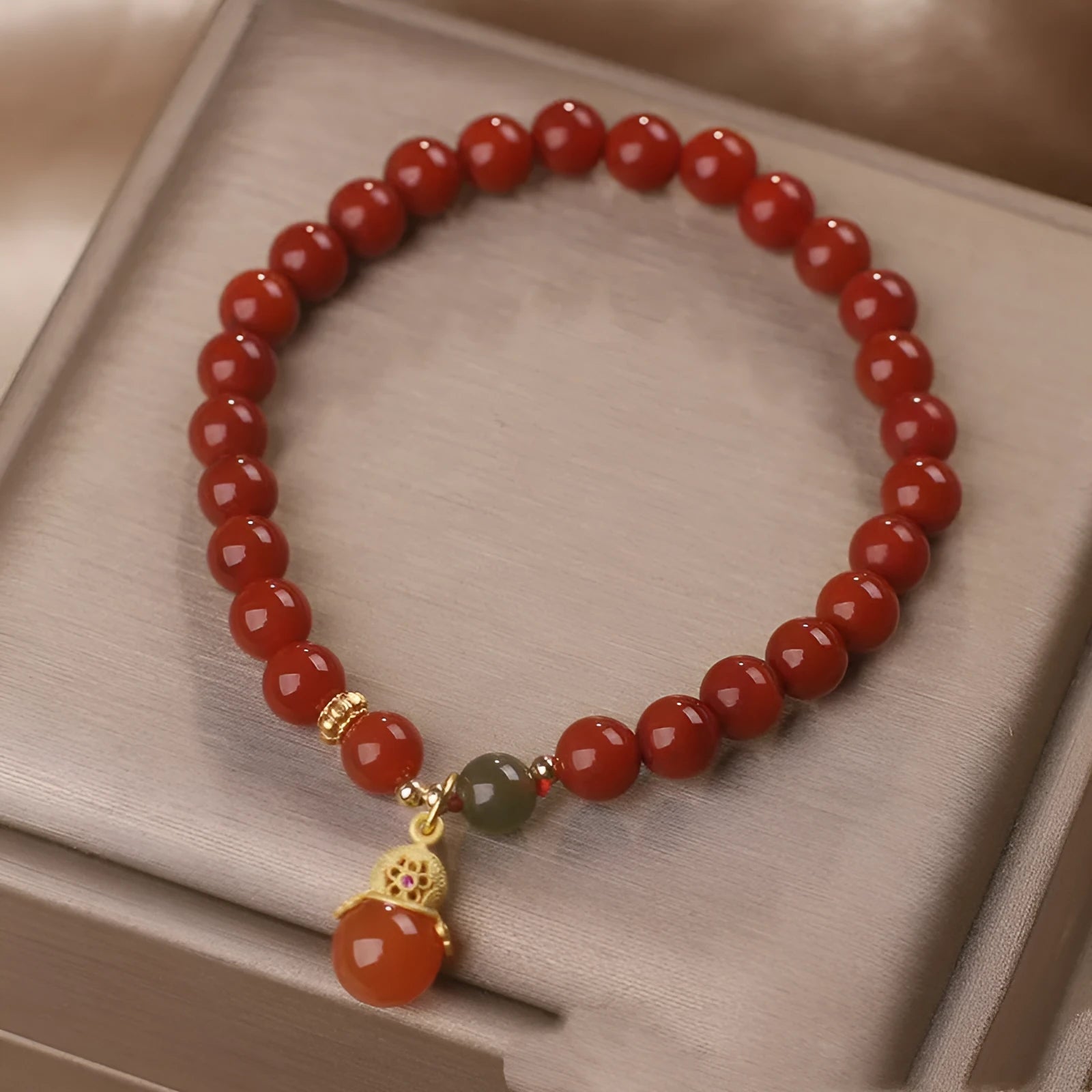 Natural red agate bracelet with zodiac pendant on wrist