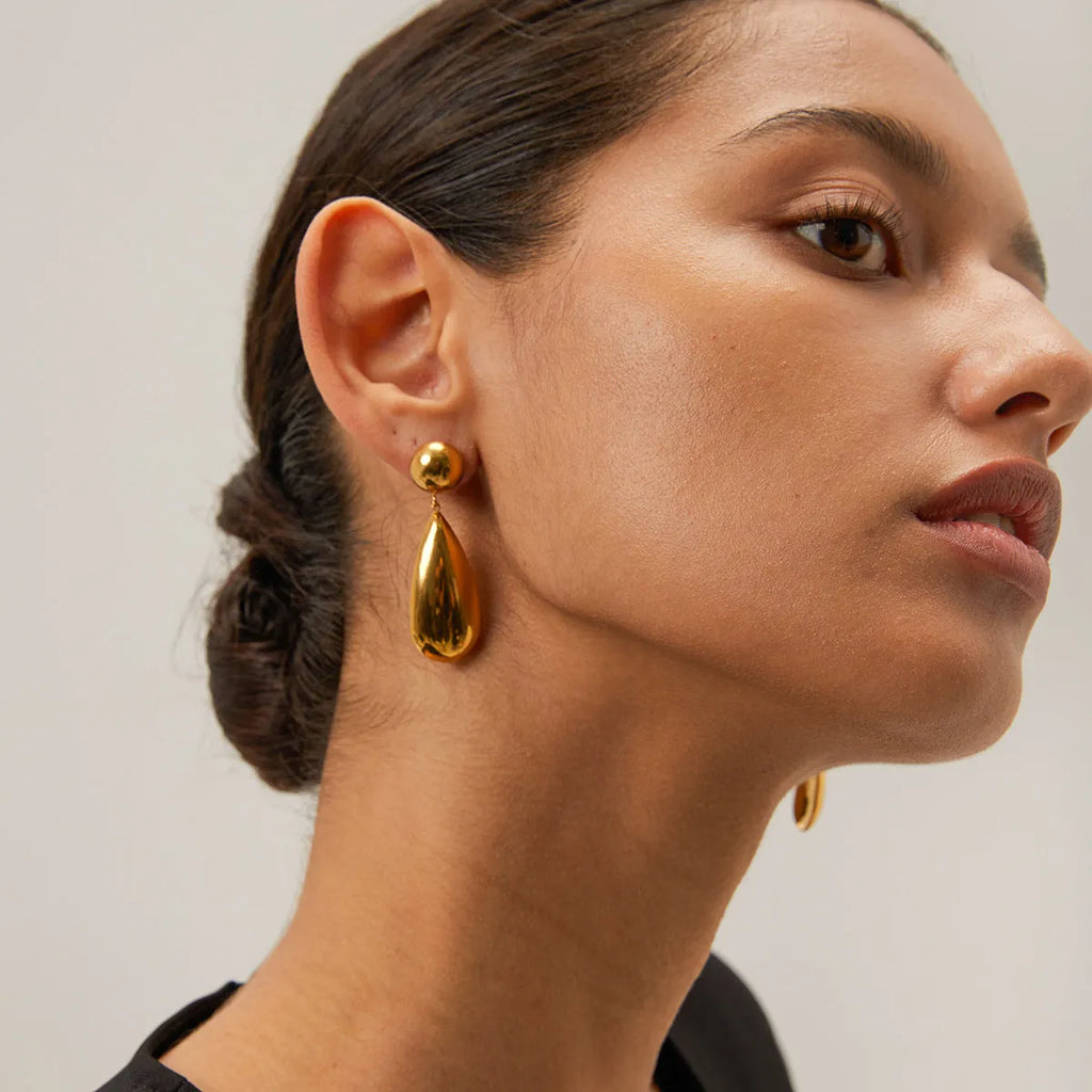 Gold-coloured stainless steel water drop pendant earrings with geometric hemisphere design