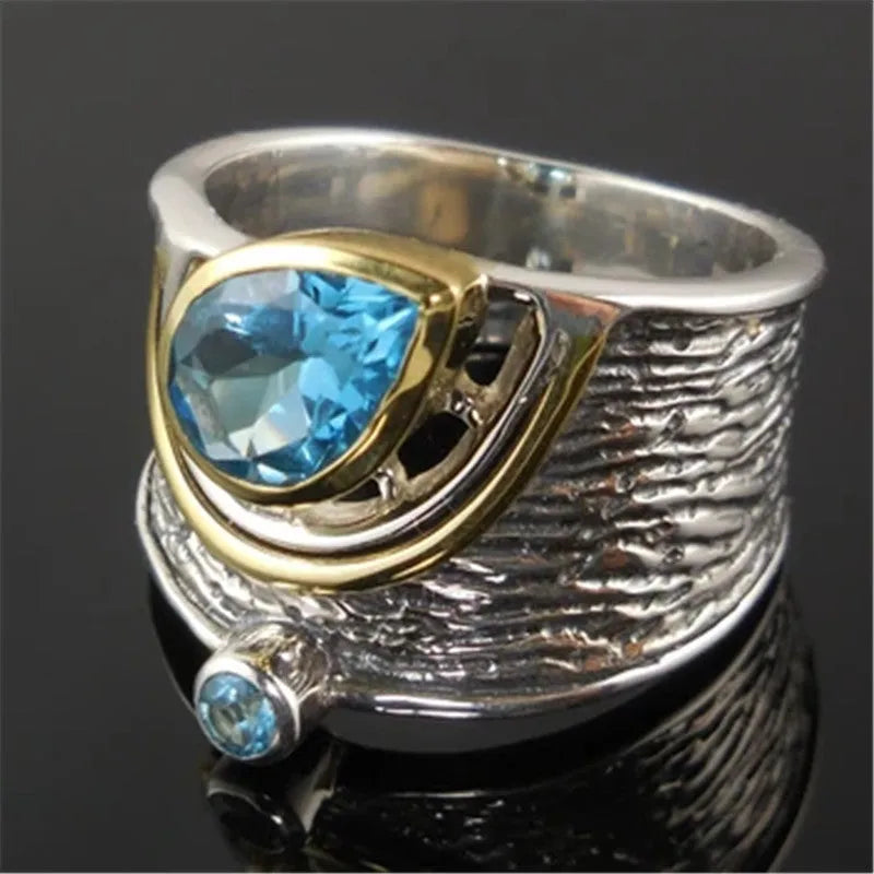 Blue rhinestone zircon drop shape ring on a white background, showing Chinese-inspired alloy design.