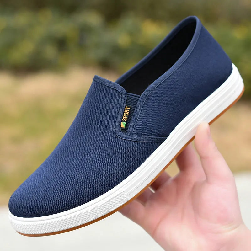 Men's low-top black and blue canvas slip-on shoes with round toe and shallow cut.