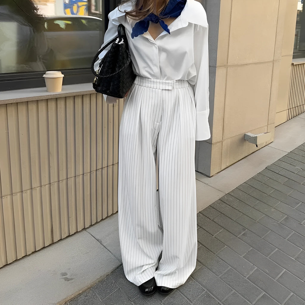 White striped wide-leg trousers with a zip fastening, laid flat.