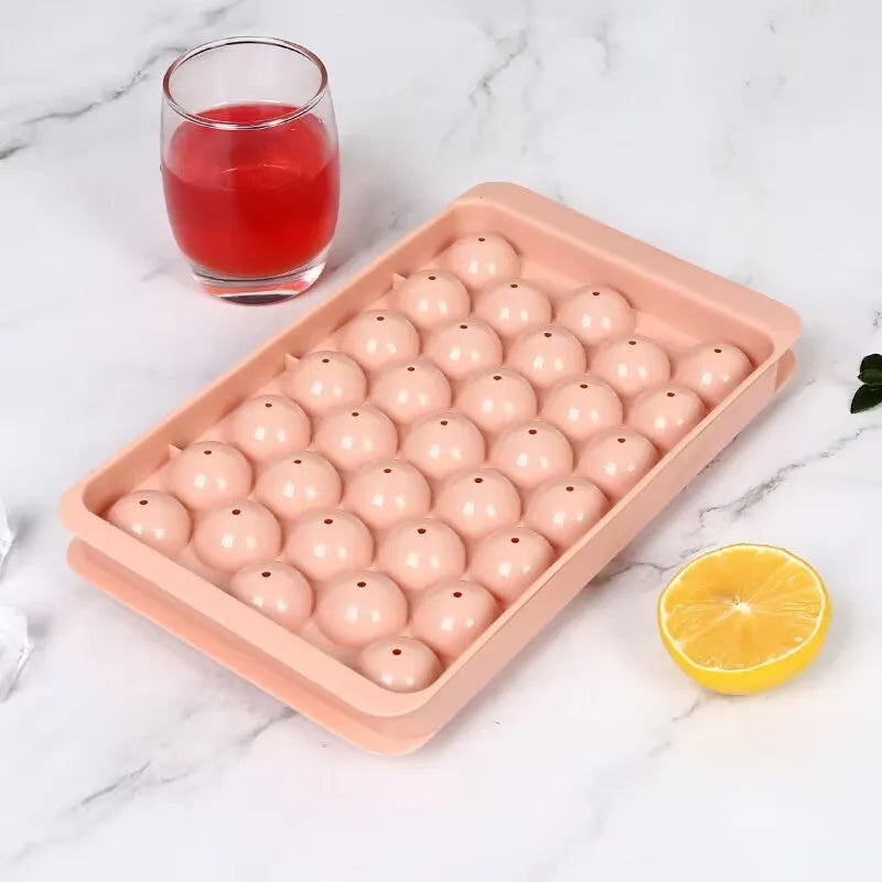 Blue silicone ice cube tray with lid showing 33 round ice cube moulds