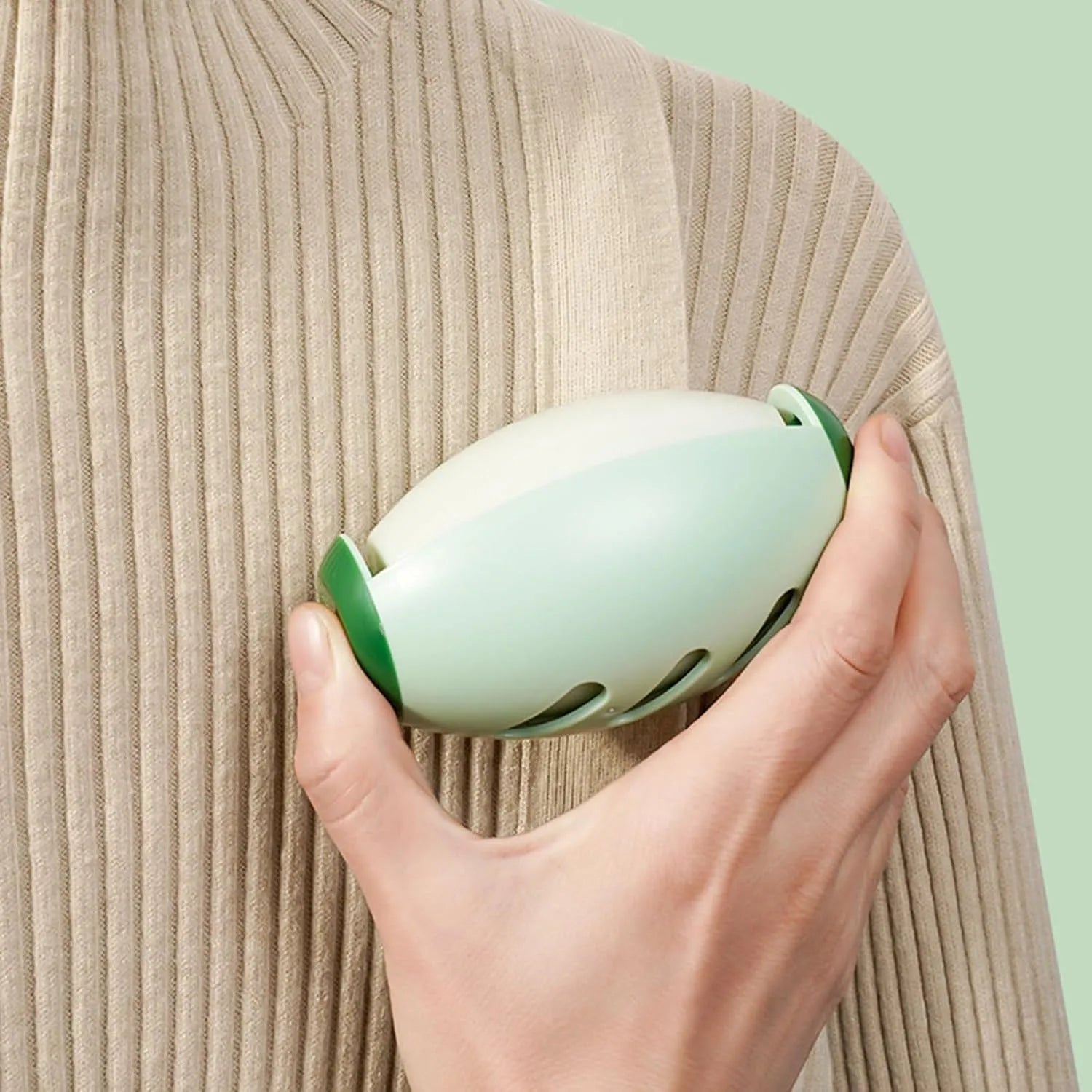 Green and white reusable gel lint roller ball for washing and removing pet hair