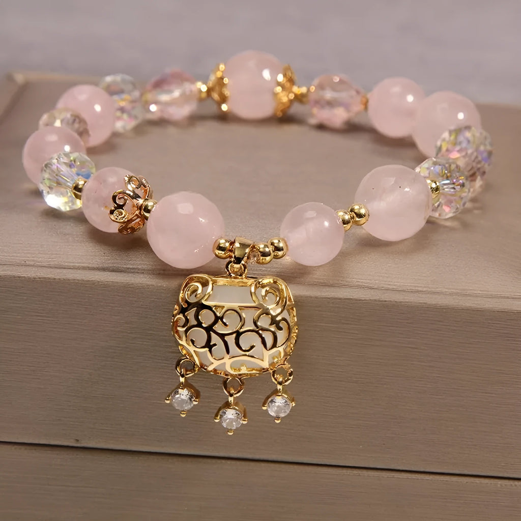 Close-up of a khaki yellow agate crystal bracelet with gold silk threading on a wrist.