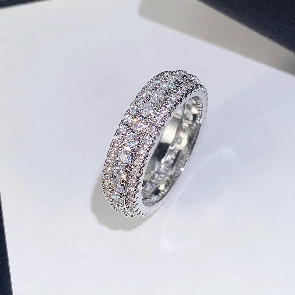 Geometric personalised engagement ring with triangular zircon stone on a copper band.