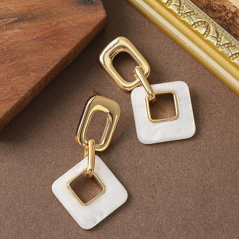 Copper hollow geometric square earrings with electroplated finish, chamfered corners, and two colour options