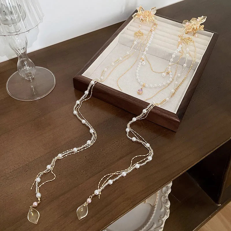 Women's gold grip hairpin with pearl, diamond flower and long tassel design