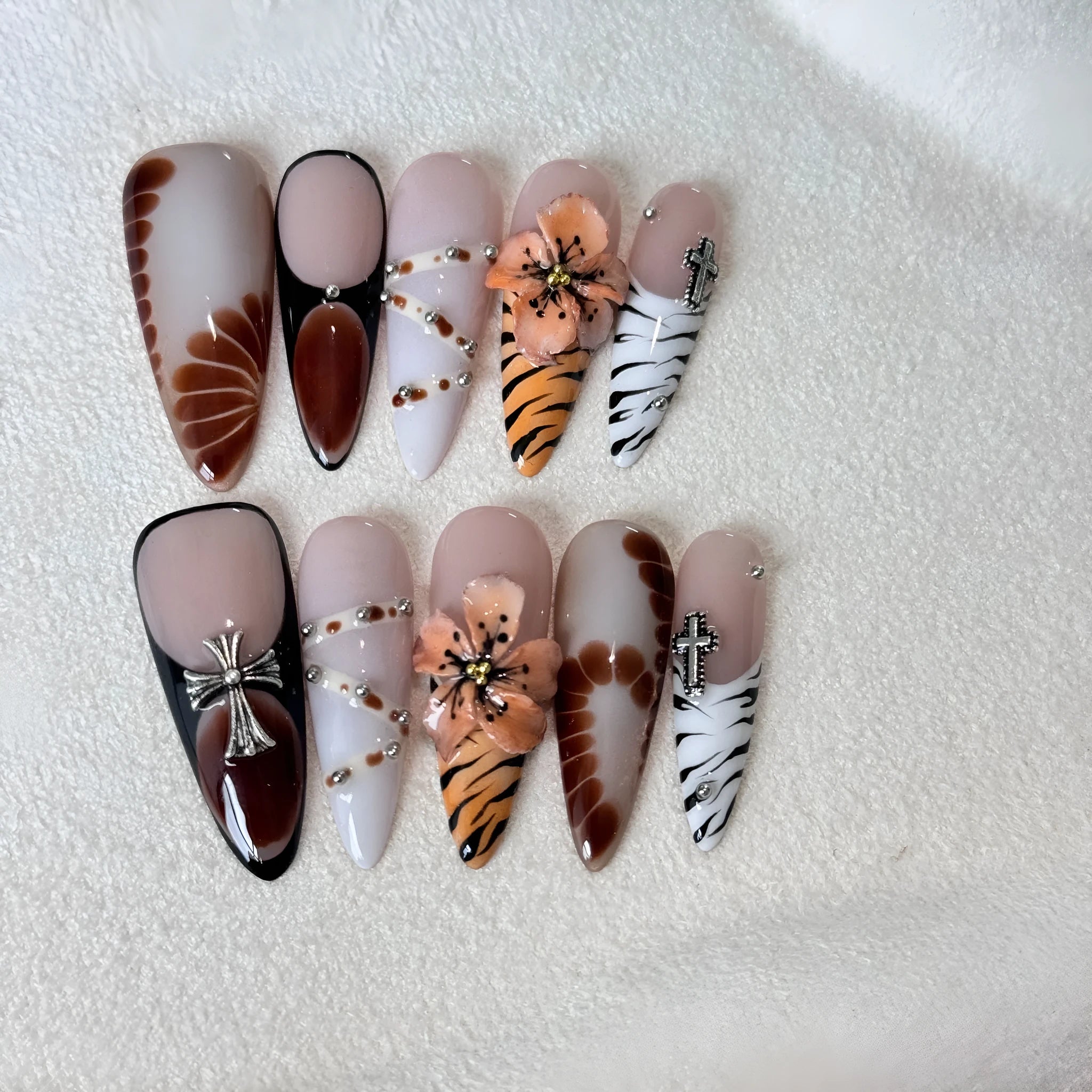 Handmade leopard, cross, and flower print nail stickers in four sizes on a backing card.