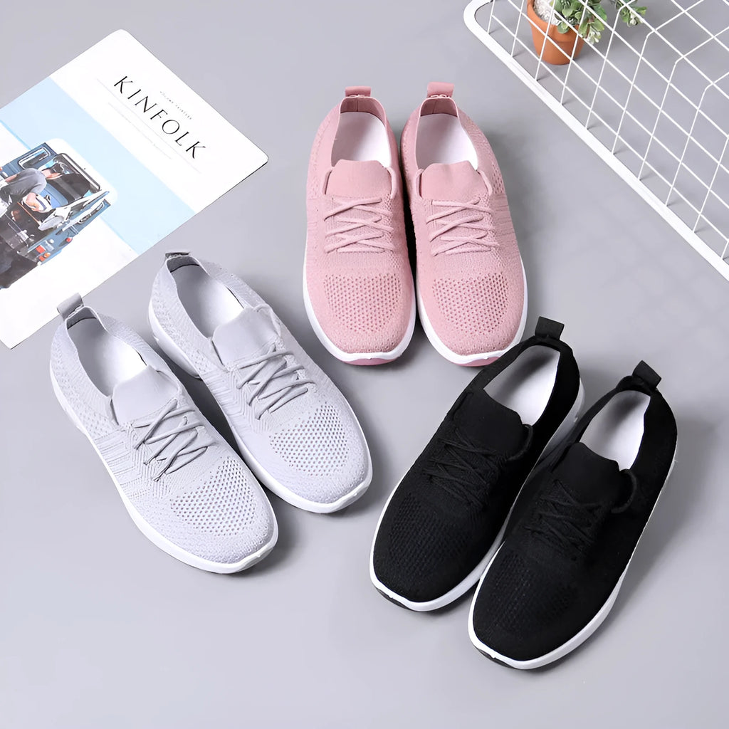 Women's solid colour mesh sneakers with round toe and white lace-up front on a grey non-slip PVC sole.