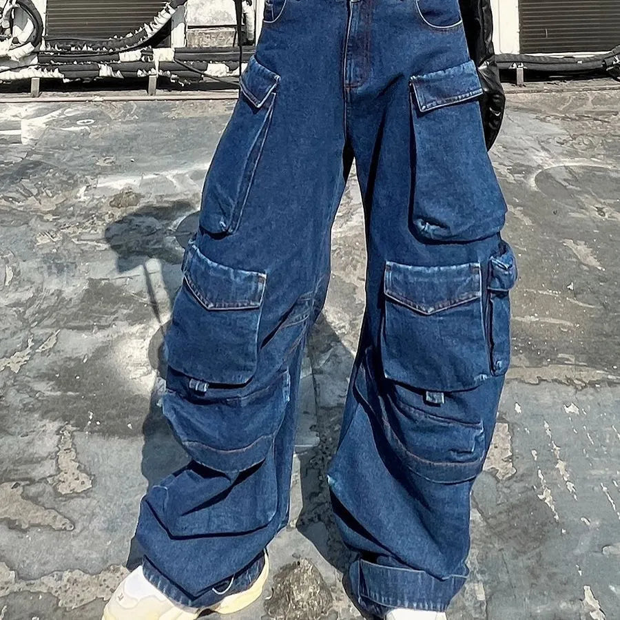 Dark blue distressed wide-leg women's jeans with a high waist and multiple pockets on a hanger.