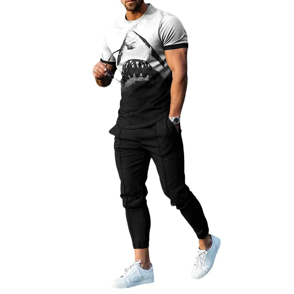 Man wearing a light grey short-sleeved pullover and matching trousers from a men's two-piece tracksuit set.