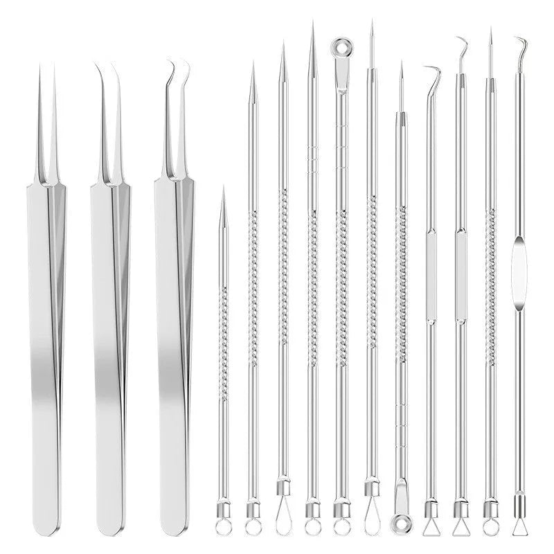 Four silver metal acne needles with fine pointed tips laid out on a surface.