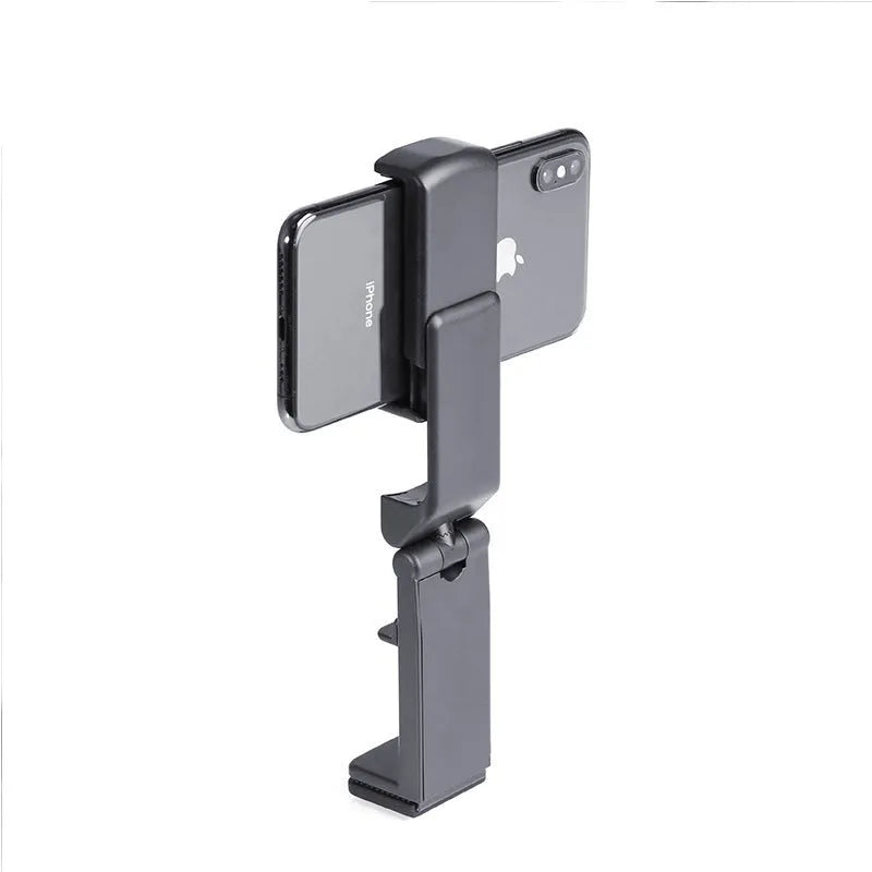 360 rotary collapsible mobile phone holder in black on a desk, with a phone propped up in landscape mode