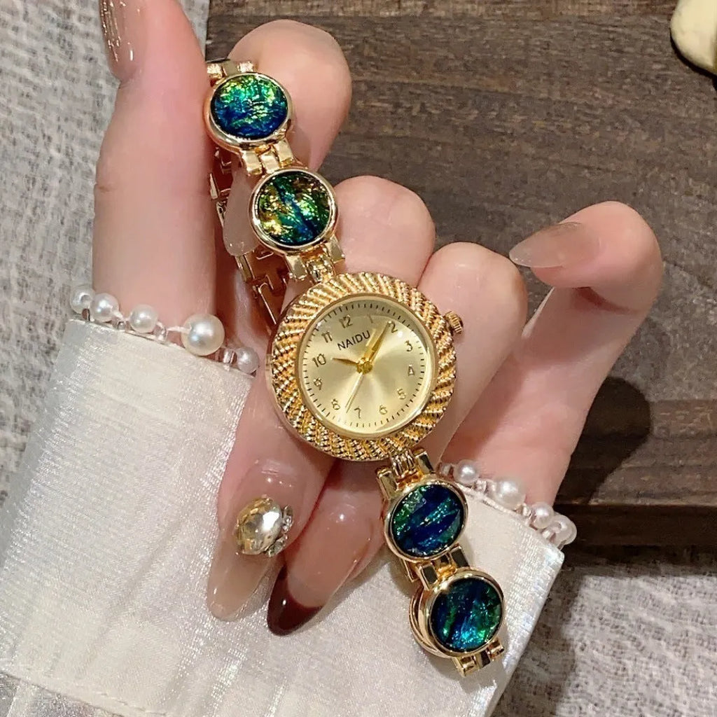 Women's 25mm round quartz watch in zinc alloy case, shown in various colours.