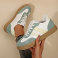 Retro women's casual low-top pumps in green with cross straps and rubber sole