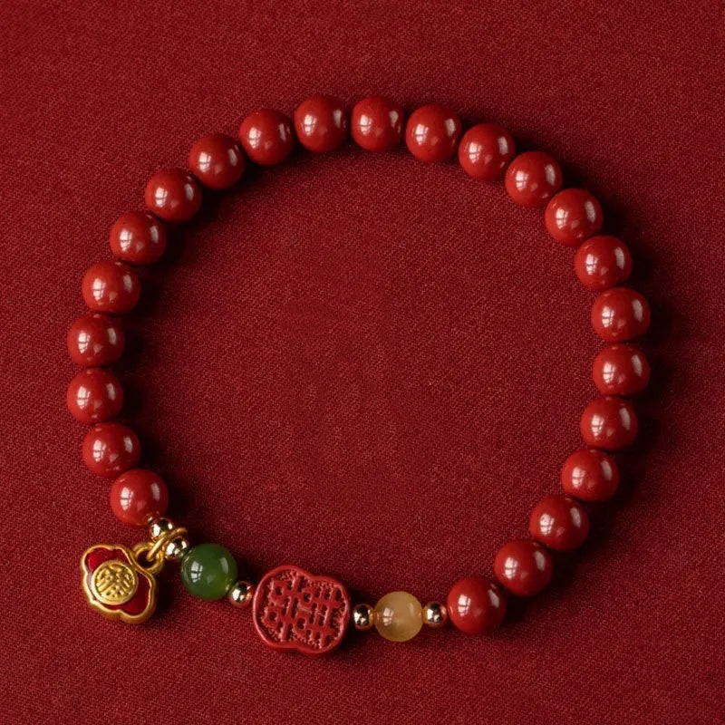 Happy Eyebrow Bracelet made of cinnabar with Emperor Sandstone beads and fu character charm.