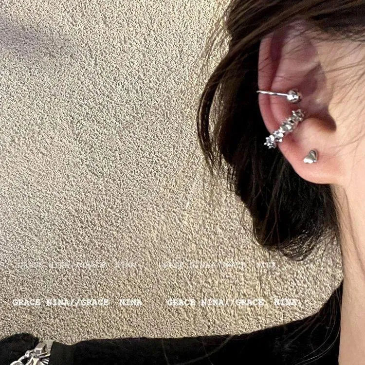 Pair of geometric irregular-shaped clip-on earrings with a frosty metallic finish.