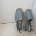 Women's beige retro fisherman flat sandals with animal print canvas uppers and a flat rubber sole.