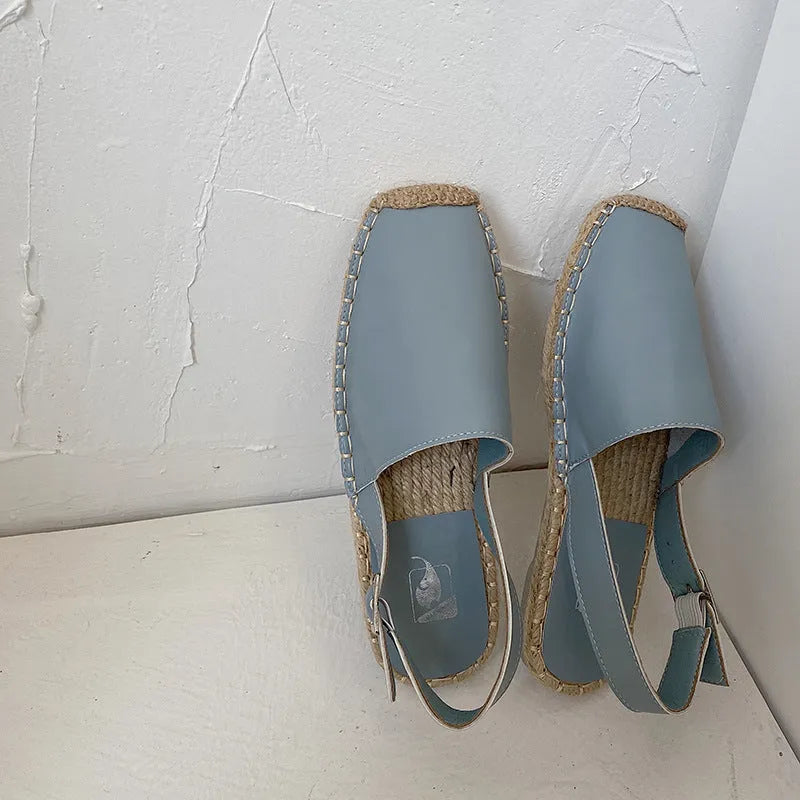 Women's beige retro fisherman flat sandals with animal print canvas uppers and a flat rubber sole.