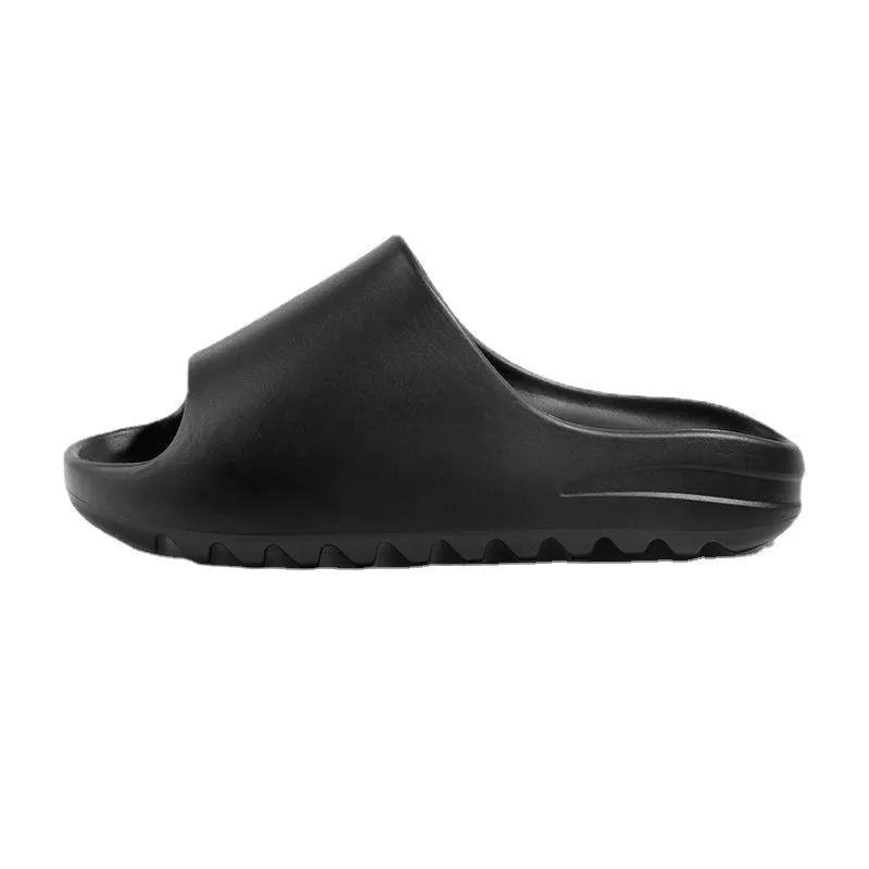 Women's beach slipper in green with a thick EVA sole, shown on a sandy background.