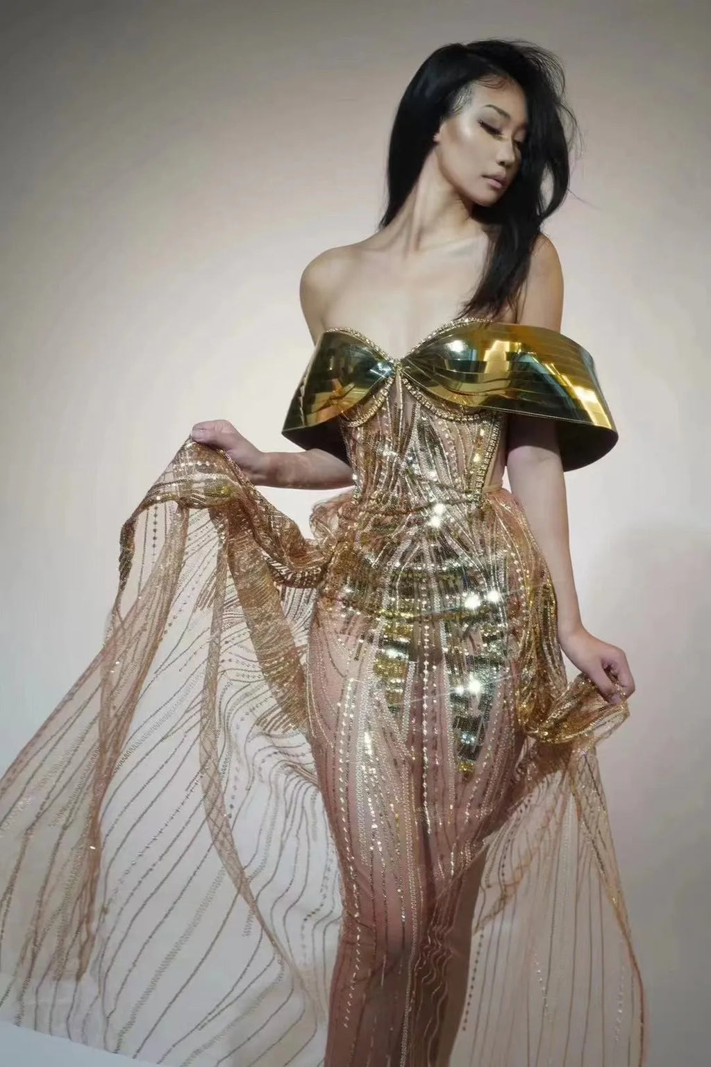 Gold sequined strapless long dress with a side split and tube top, shown on a model.