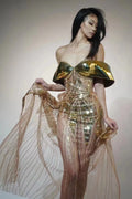Gold sequined strapless long dress with a side split and tube top, shown on a model.