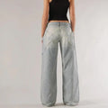 Women's blue cotton wide leg mop trousers with low waist and splicing detail laid flat.