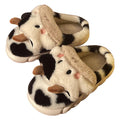 White cartoon cow slippers for women with fluffy faux fur and a textured non-slip sole.