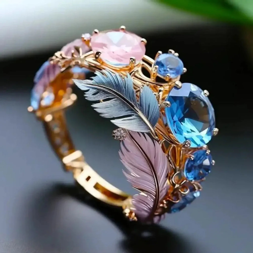 Geometric gold brass ring with colourful embossed feather design and zircon detailing