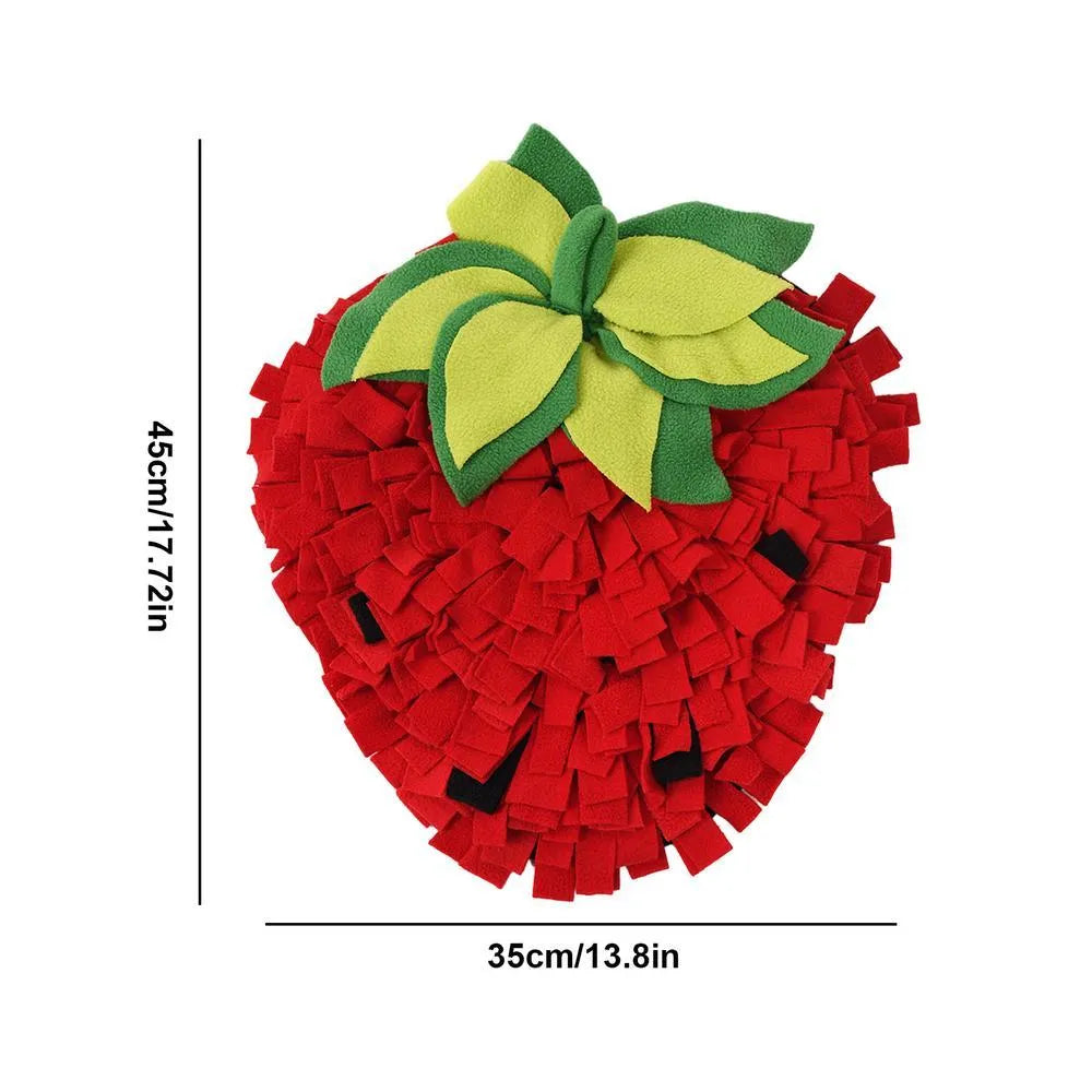Red and green strawberry-shaped pet sniffing mat for dogs and cats on a wooden floor
