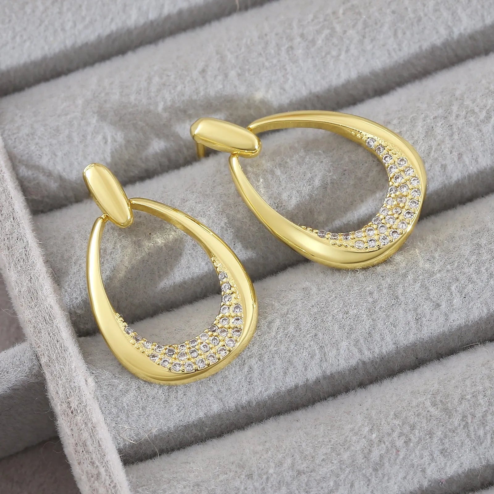 Yellow gold geometric drop earrings with zircon detailing measuring 2.6 by 1.7 centimetres