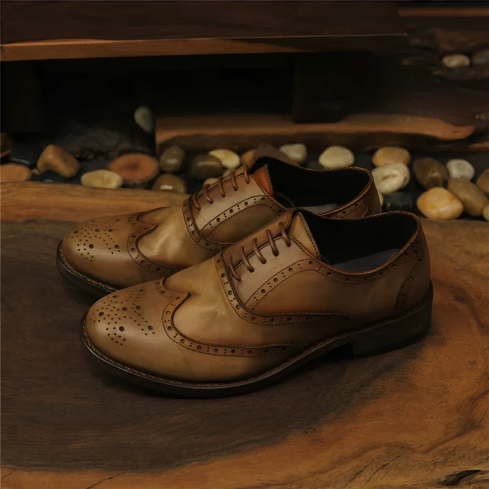 Men's light brown vintage leather lace-up shoes with carved detailing and a round toe.