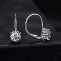 Close-up of a sterling silver floral bud ear clip with a moissanite stone and white gold plating.