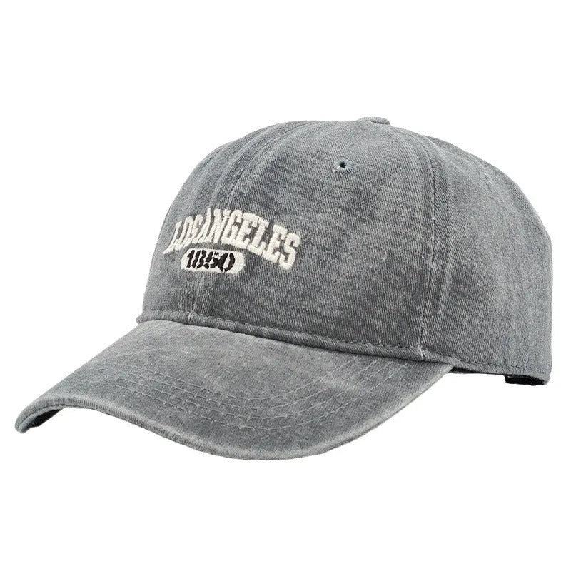 Adjustable peak cap with embroidered letters in distressed retro style, showing conical crown and 7cm brim