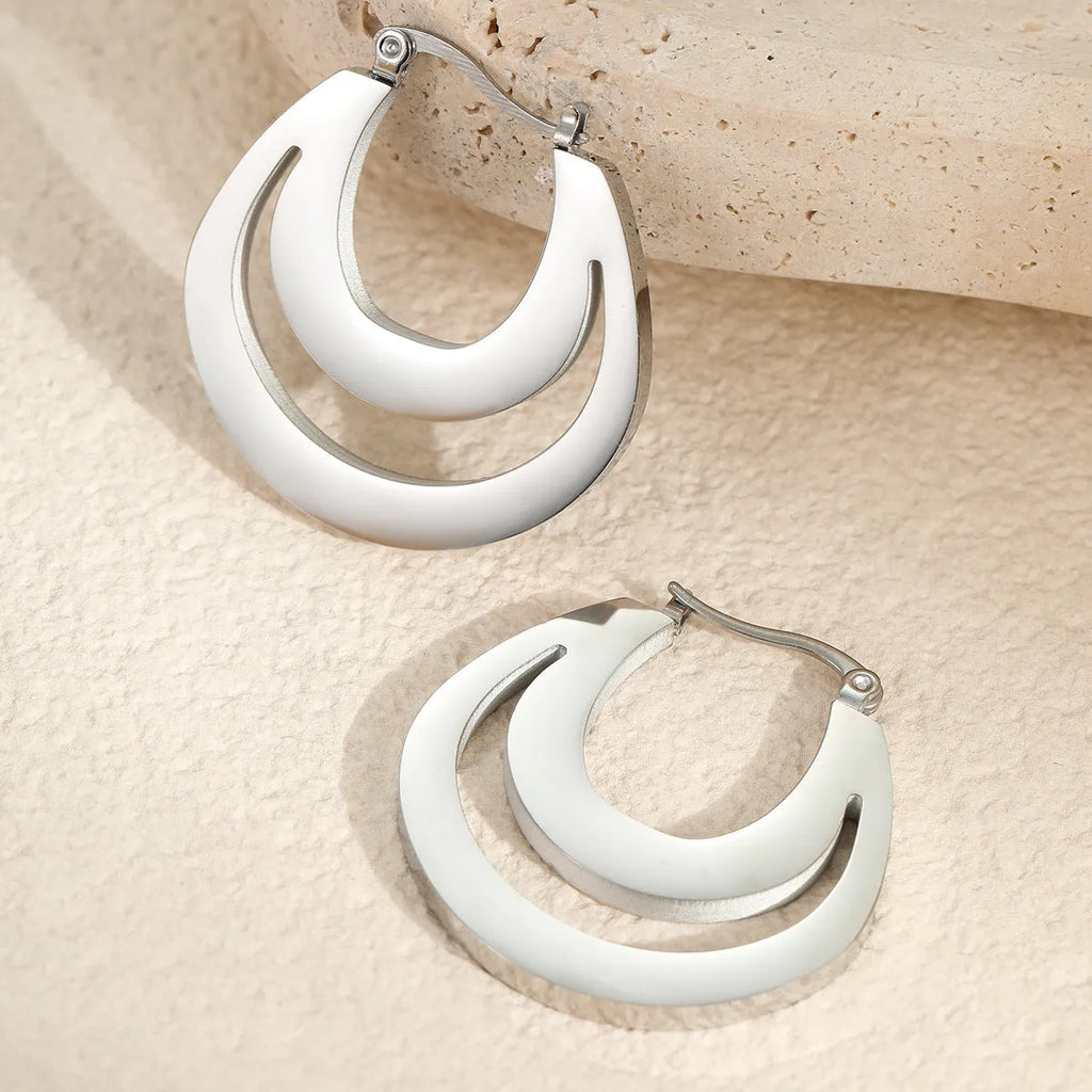 Geometric French earrings with 18K gold plating on stainless steel, featuring round ring elements in minimalist design