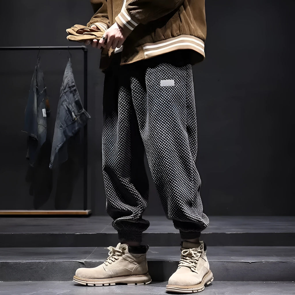 Grey men's straight-leg sweatpants with ankle ties laid flat.