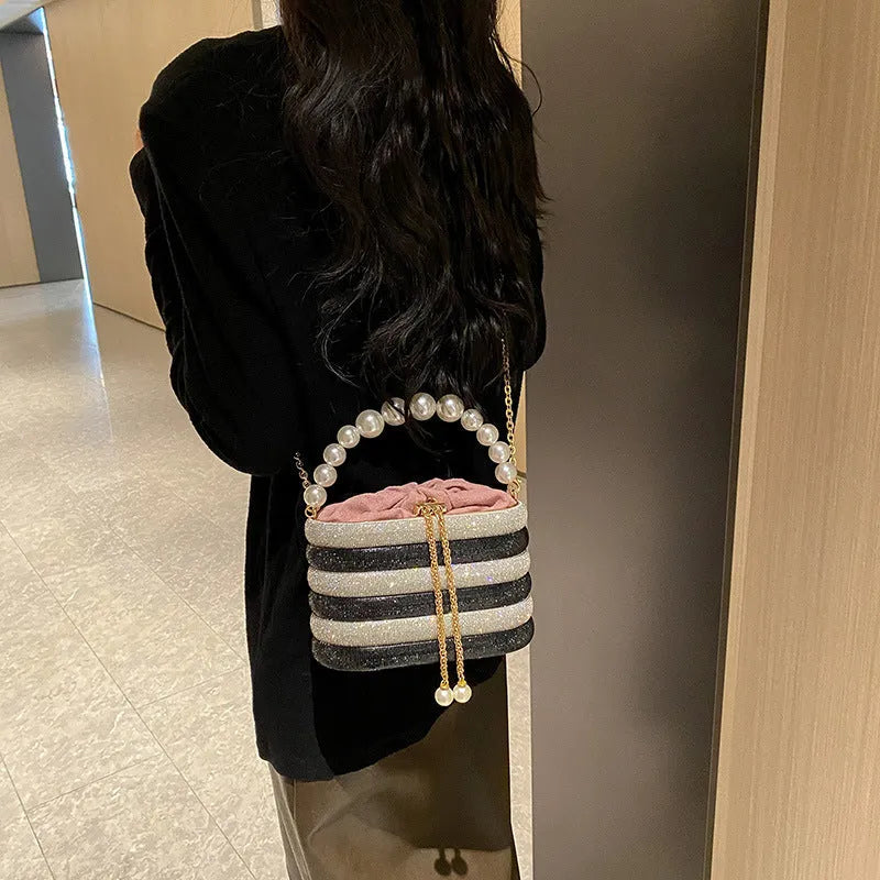 Women's retro style crossbody bag with beaded pearl detail on soft PU material in rounded suitcase shape