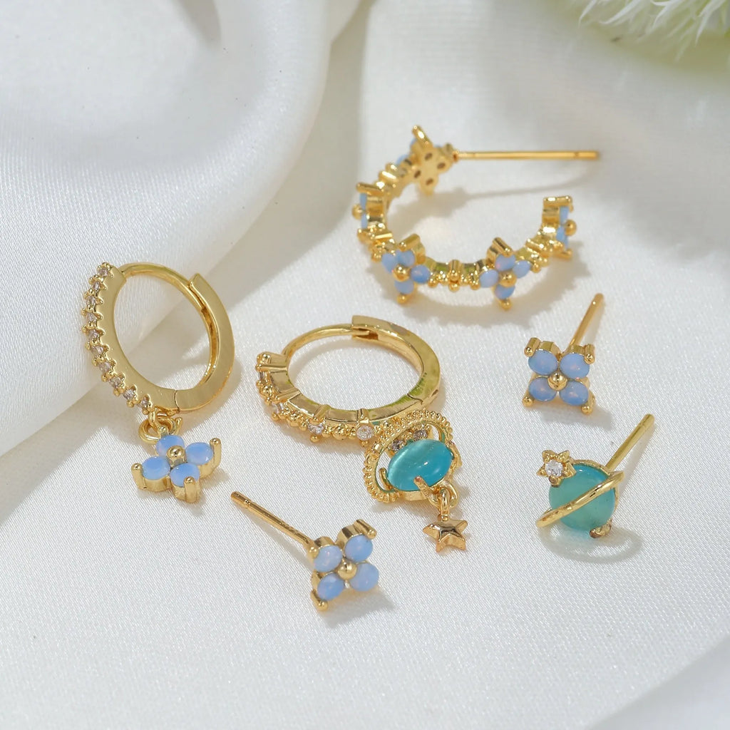 Gold and silver Japanese Korean style flower earrings studs with blue zircon mosaic detail.