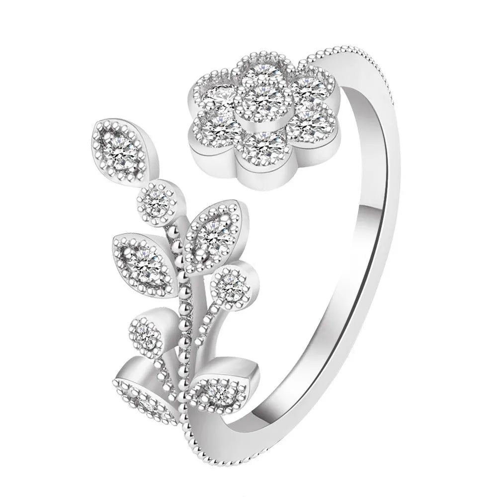 Women's open mouth copper ring with diamond-textured flower and leaves design in gold or white finish.