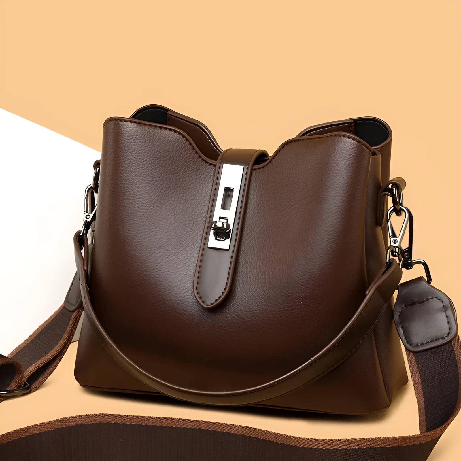 Textured PU bucket bag in black with patchwork stitching, horizontal rectangular shape, single shoulder strap.